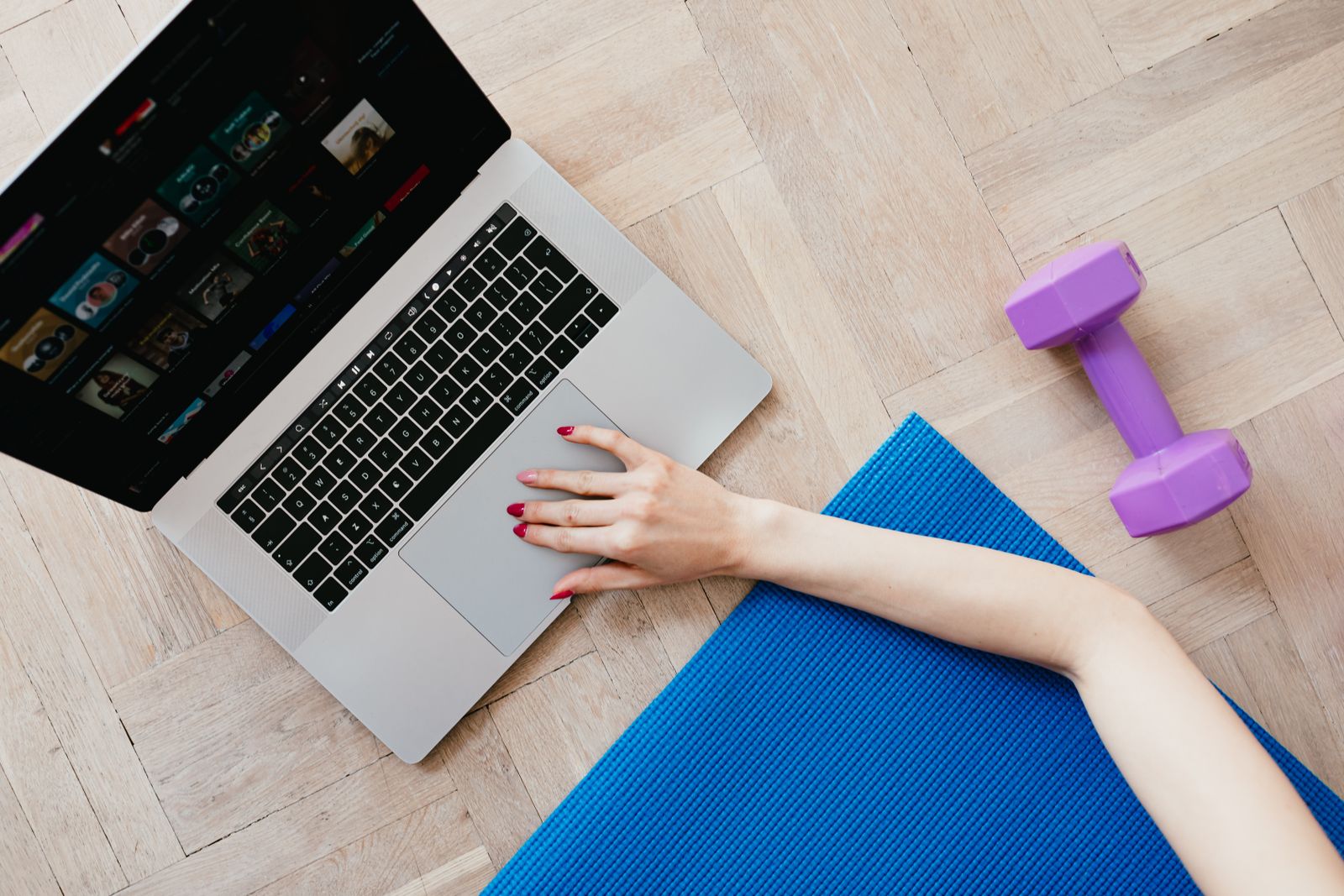 Workout mat, laptop, and light dumbbells for building sustainable fitness habits