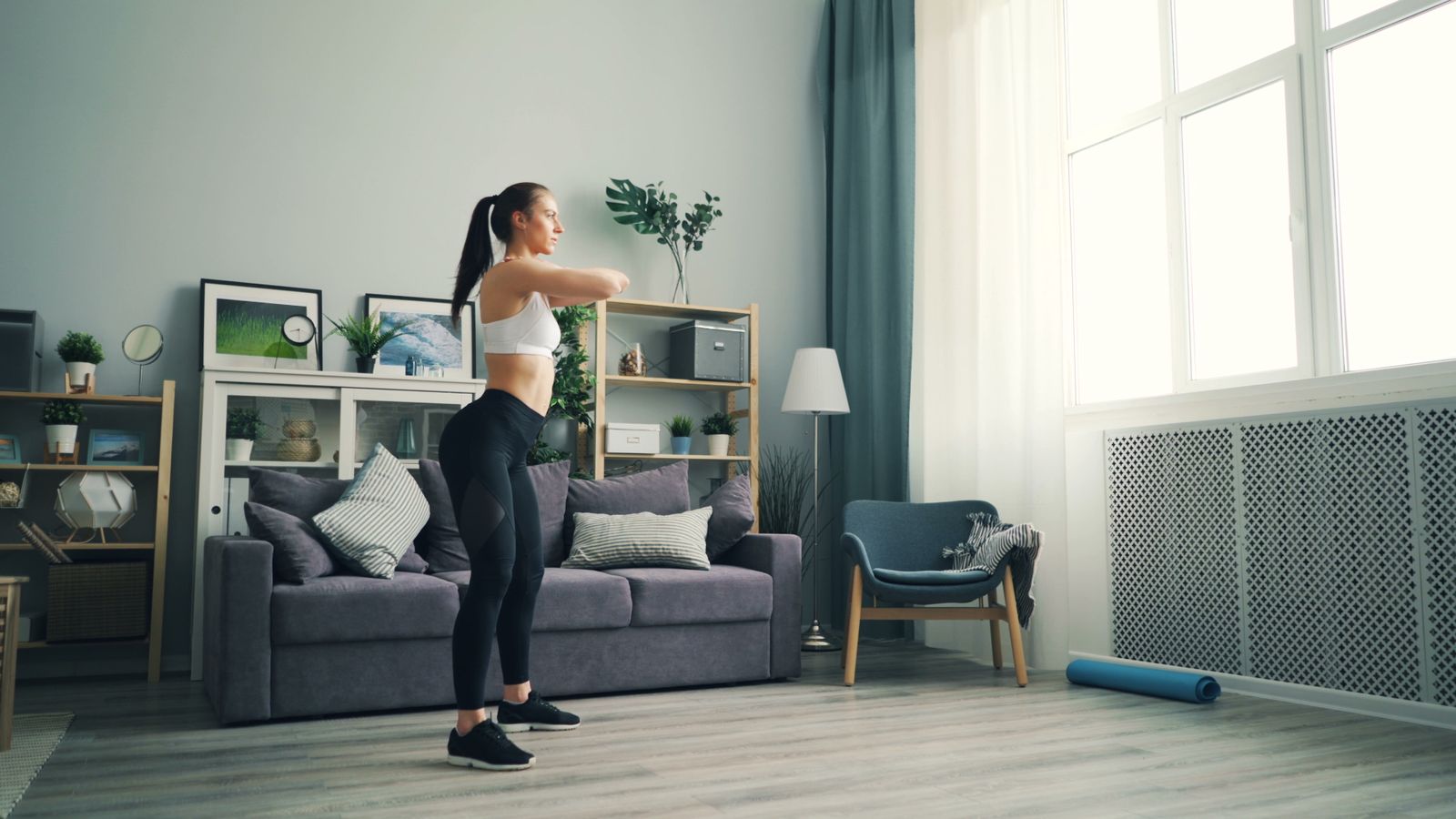 Person doing a home workout with dumbbells and a timer