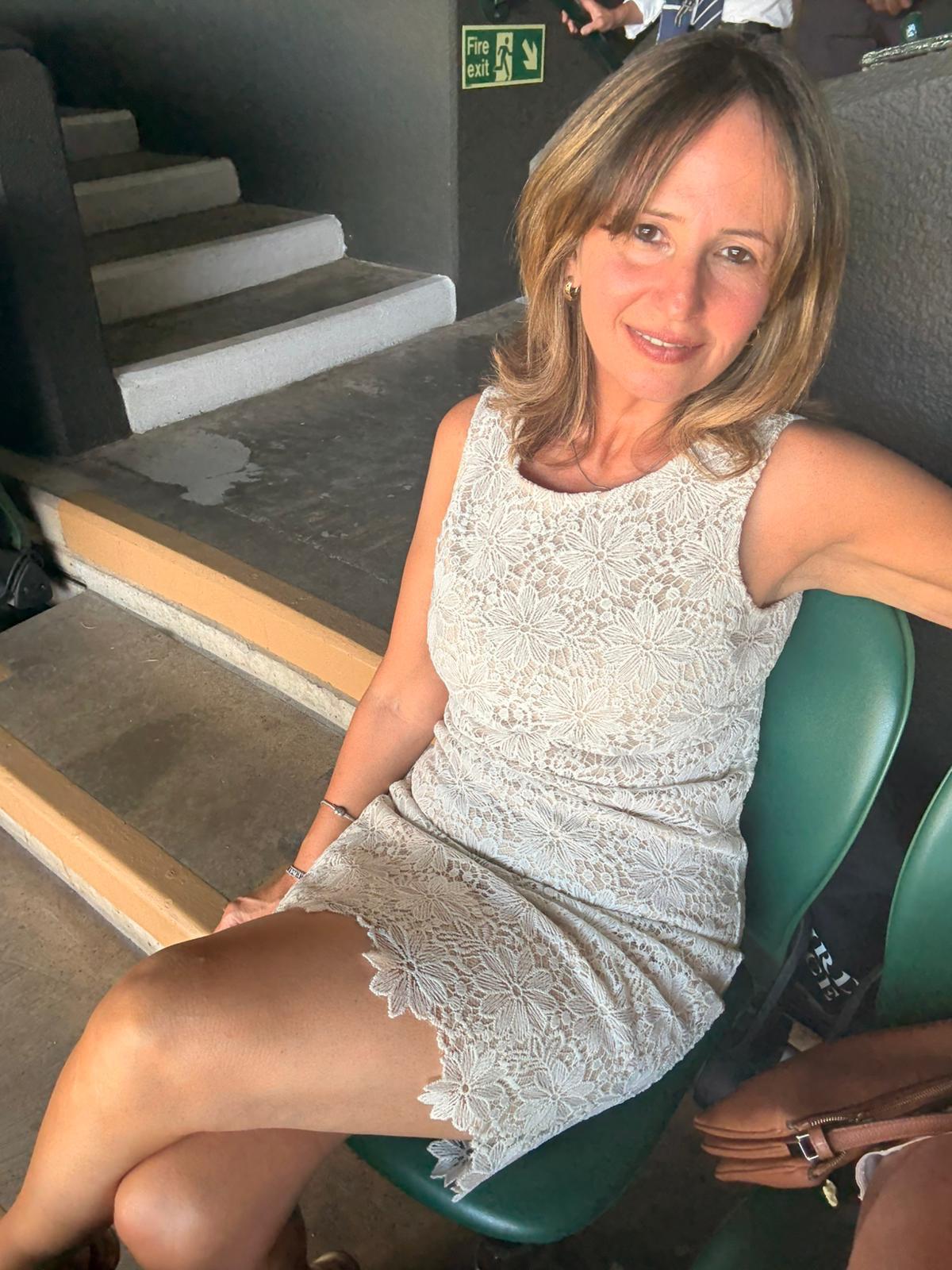 Client showing back progress in the gym mirror